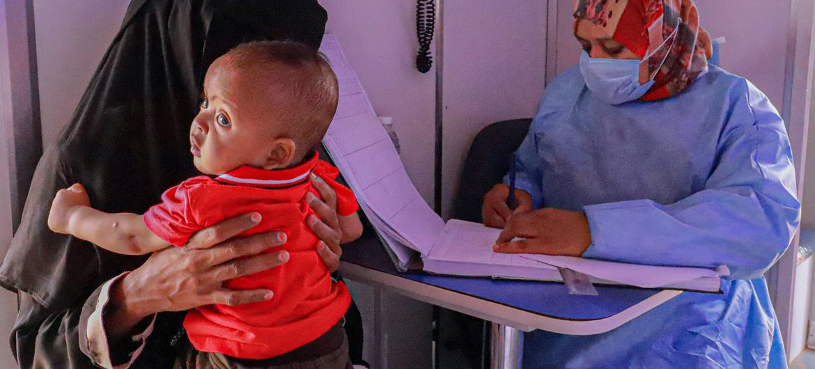 A Sudanese refugee takes her baby for a health check in Alkufra in eastern Libya.
