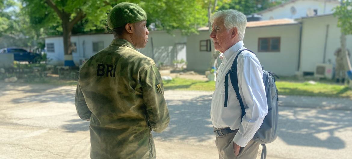 William O'Neill (right), talks to a Haitian police officer in Port-au-Prince during a visit to the country in October 2023.