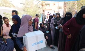 People in Gaza collect winter clothes supplies.