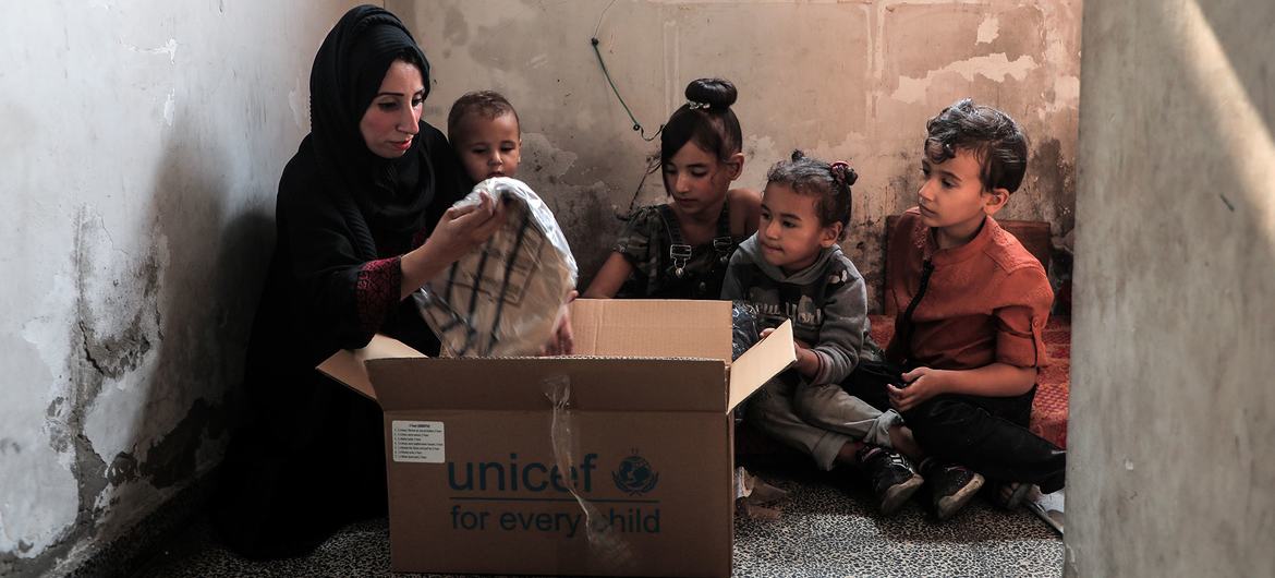 UNICEF distributes winter clothes kits to children across the Gaza Strip, as winter storms are adding to families' hardship.