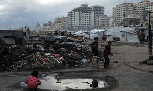 A child plays in a puddle in the Al-Rashid Street area of Gaza.