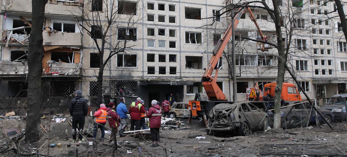 Rescue workers clean up following an airstrike  on the Ukrainian capital, Kyiv, on 12 December, 2023.