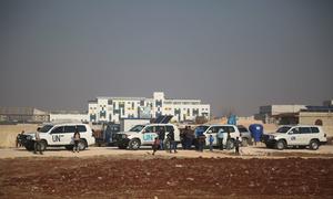 UN vehicles pause during a journey through Aleppo in Syria.