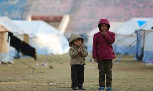 Children stand at a reception centre for newly arrived displaced families in Raqqa city, Syria.