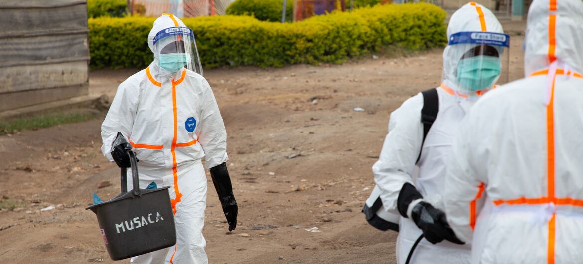 UNICEF-supported hygienists in full protective gear disinfect a tent at the Centre Médical Evangélique hospital in Bunia, DRC, during the 2026 Ebola outbreak.