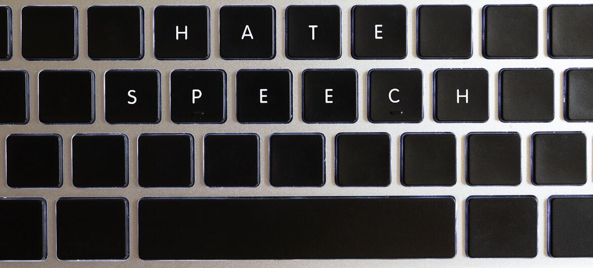 A close-up of a computer keyboard with the words ‘HATE SPEECH’ written on the keys.