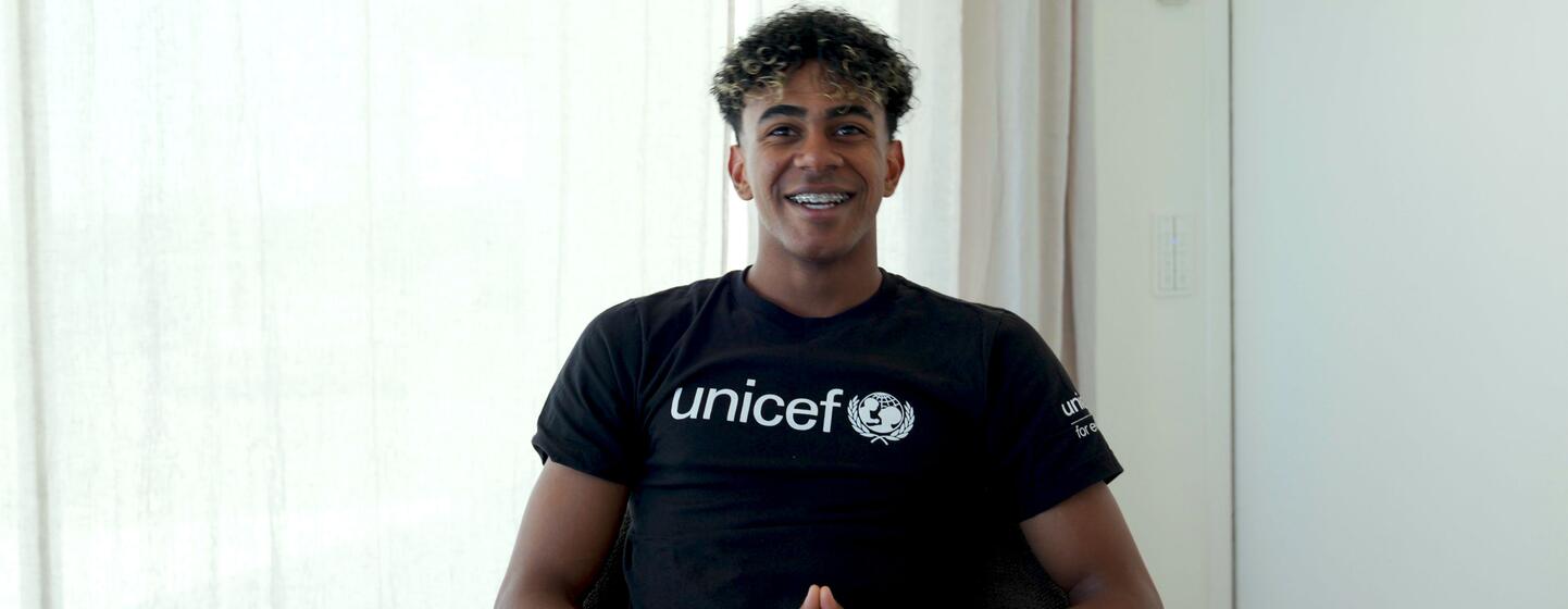 UNICEF Goodwill Ambassador Lamine Yamal smiles while wearing a black UNICEF t-shirt.
