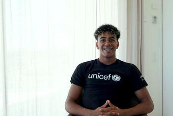 UNICEF Goodwill Ambassador Lamine Yamal smiles while wearing a black UNICEF t-shirt.