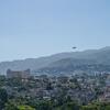 UNHAS helicopter flying over the Port-au-Prince urban landscape in Haiti.