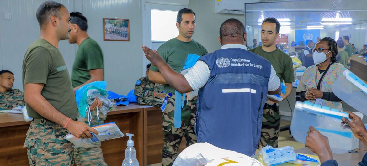 In Goma, DR Congo, a WHO representative in a blue vest trains MONUSCO's healthcare personnel in infection prevention and control procedures.