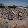 Amjad and a colleague clear rubble in Jabalia, Gaza, to make space for displaced families.