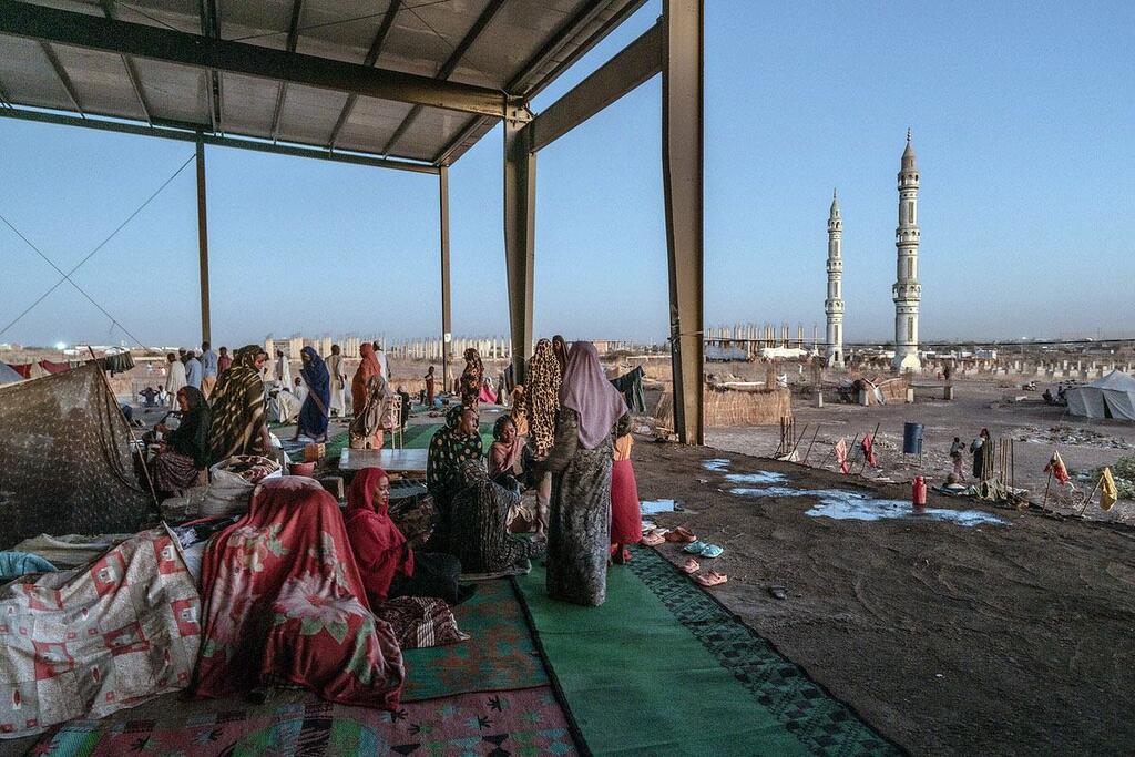 People displaced by conflict take shelter at a bus station in Gedaref, Sudan.