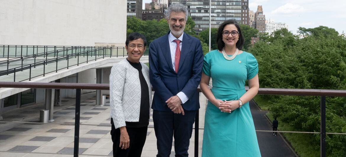 Maria Ressa, Yoshua Bengio, and Egriselda López pose for a formal group portrait on an outdoor terrace in New York.