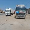 WHO trucks carrying medical supplies are parked on a dusty road in Sudan.