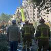 UNICEF staff and firefighters walk towards a heavily damaged building during a rescue operation in Kyiv, Ukraine.
