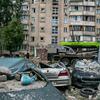 Damaged cars and debris in front of a damaged apartment building in Kyiv, Ukraine, following a drone and missile attack.