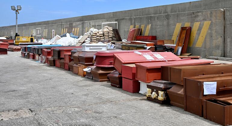 Numerous coffins of various colors are stacked on a concrete dock in La Guaira, Venezuela, following the devastating twin earthquakes of June 2026.