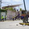 Personal de emergencia y equipos de rescate permanecen apostados frente a un edificio derrumbado en La Guaira, Venezuela, donde se han escrito en una pared los nombres de las personas desaparecidas.