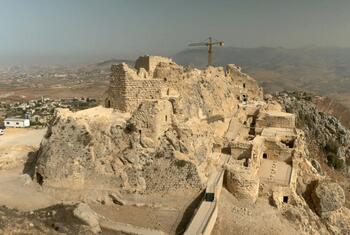 Aerial view of the ruins of Beaufort Castle, a fortified site in the Mount Amel region of southern Lebanon, with a construction crane visible in the background.