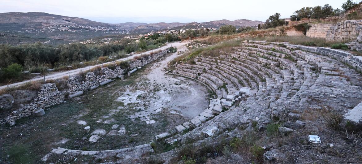 Ancient Roman Theatre with the village of Sebastia in the background, Palestine