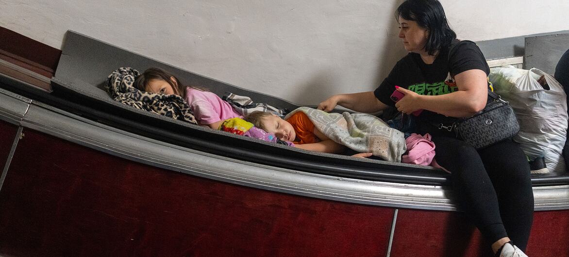 A mother and her two young children seek shelter from overnight attacks inside a metro station in Kyiv, Ukraine.