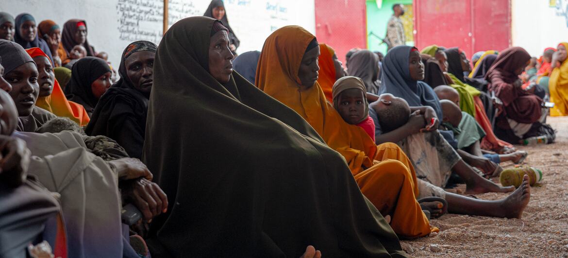 Women and children wait for treatment at a health center in Burhakaba, Somalia.