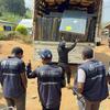 Des travailleurs humanitaires de l'OMS à Nizi, en RDC, déchargent des matelas et des lits d'un camion afin d'augmenter la capacité d'un centre de traitement d'Ebola.