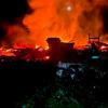 A large fire engulfs a warehouse at night in Dnipro, Ukraine.
