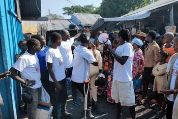Former combatants and community members participate in an Ebola awareness campaign in Tchomia, Ituri Province, DR Congo.