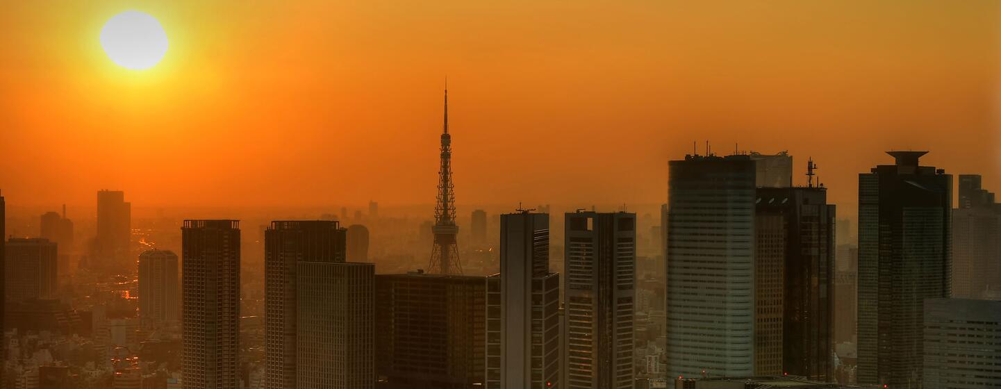Japan’s ‘2050 Weather Forecast’ highlights extreme heat in the future 1 Silhouetted Tokyo skyline with Tokyo Tower against a hazy orange sunset.