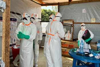 Healthcare workers in full protective gear prepare for an Ebola vaccination campaign in the Democratic Republic of the Congo.
