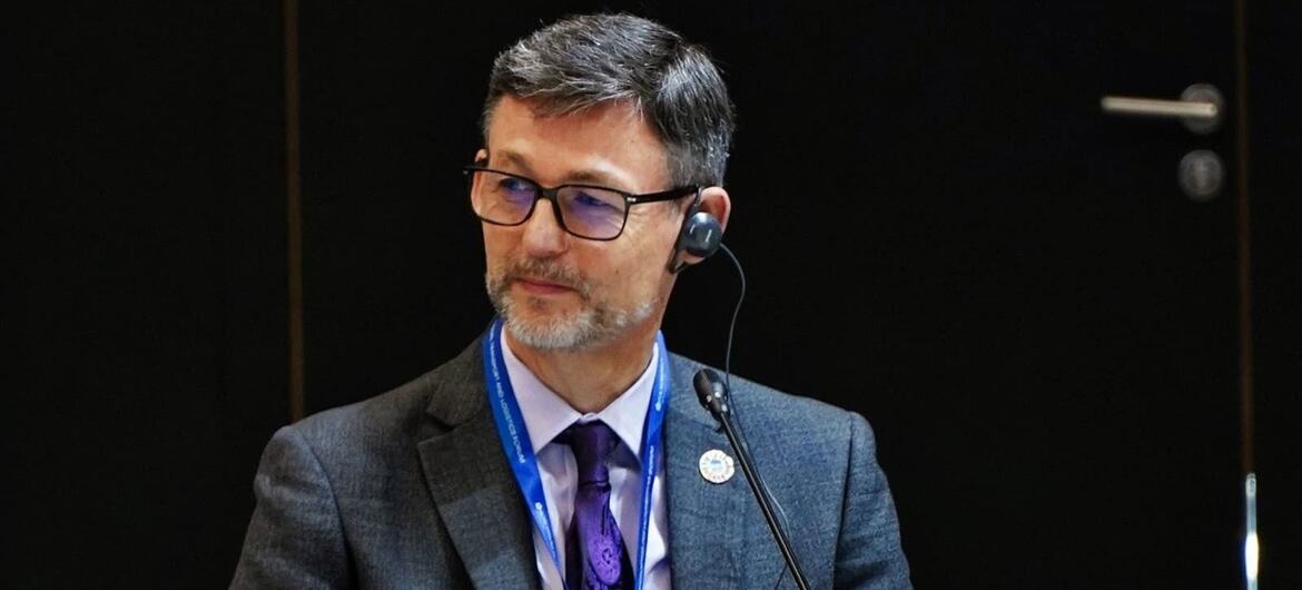 Damien Chevallier, Director of the Maritime Safety Division at the International Maritime Organization (IMO), seated at a conference table with a nameplate in front of him.