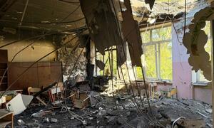 Interior of a school classroom in Odesa, Ukraine, showing a collapsed ceiling, exposed wires, rubble, and damaged children's desks after a September 2026 attack.
