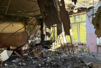 Interior of a school classroom in Odesa, Ukraine, showing a collapsed ceiling, exposed wires, rubble, and damaged children's desks after a September 2026 attack.