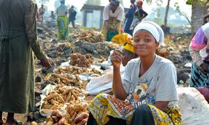 A woman sells food at a market in the Democratic Republic of the Congo.