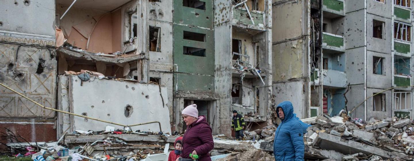 Des gens passent devant un bâtiment endommagé par les bombes à Tchernihiv, dans le nord de l'Ukraine.