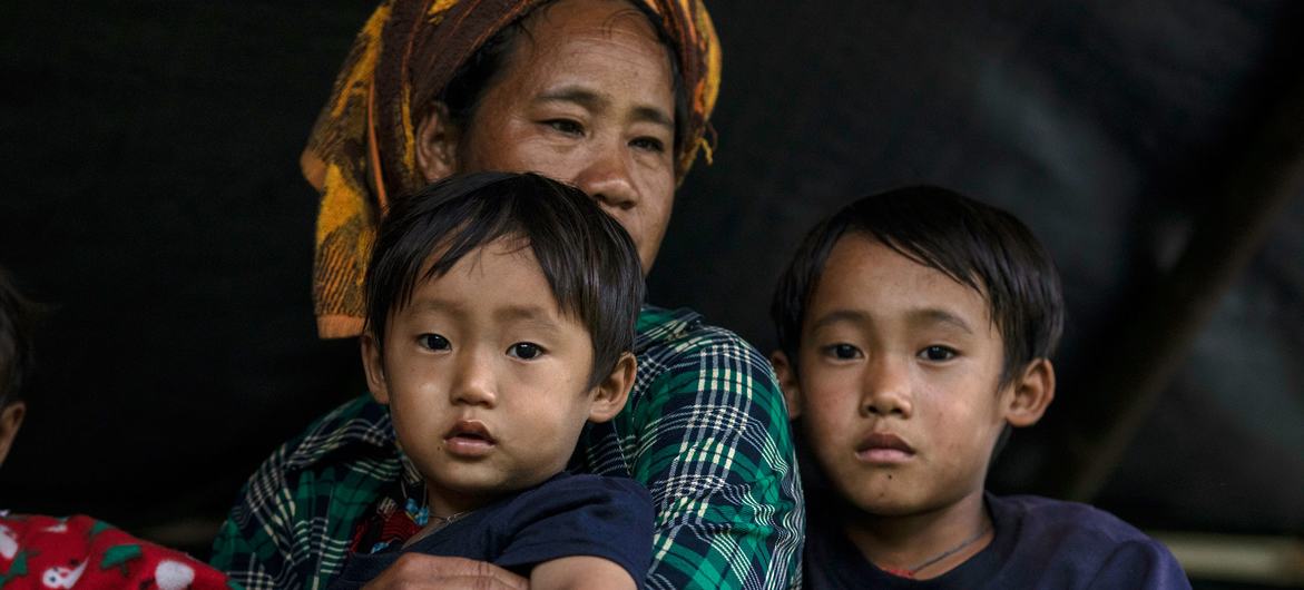 A family arrives to safety after fleeing the restive east of Myanmar.