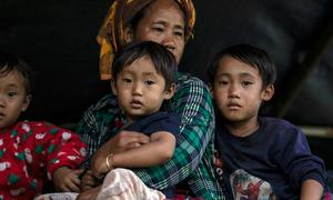 A family arrives to safety after fleeing the restive east of Myanmar.