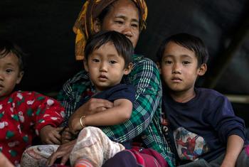 A family arrives to safety after fleeing the restive east of Myanmar.