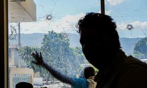 A UN staff member tours a building targeted by gangs in Port-au-Prince.