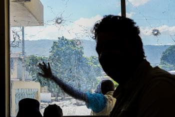 A UN staff member tours a building targeted by gangs in Port-au-Prince.
