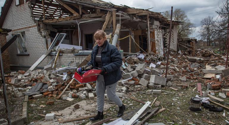 A woman retrieves possessions from her bombed house in the village of Novoselivka, near Chernihiv, Ukraine.