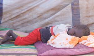 A young boy who fled El Fasher with his family rests in a camp for displaced people. (file)