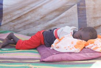 A young boy who fled El Fasher with his family rests in a camp for displaced people. (file)