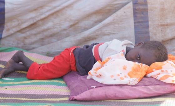 A young boy who fled El Fasher with his family rests in a camp for displaced people. (file) A young boy who fled El Fasher with his family rests in a camp for displaced people. (file)