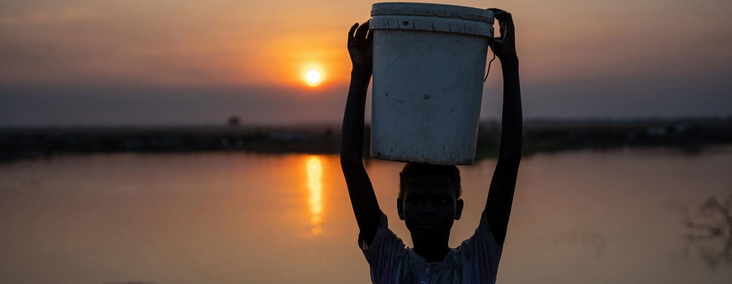 A girl carries water to her home at a camp for internally displaced people in Bentiu, South Sudan.