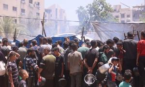 People gather at a food distribution site in Gaza.