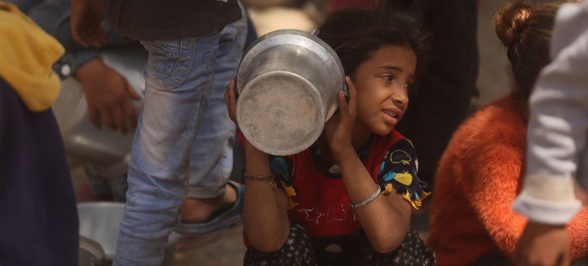 A child waits for food in Gaza. A child waits for food in Gaza.