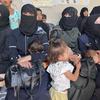 Mothers and their children in Syria waiting to be tested for malnutrition.