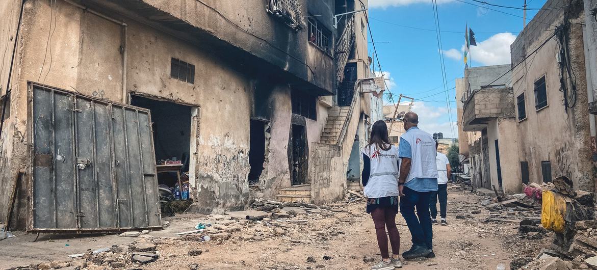 Aid workers assess the damage following a military raid on a refugee camp in Jenin. (file, July 2023)